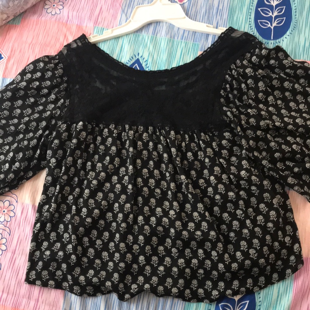 black blouse with shower print and a lace panel